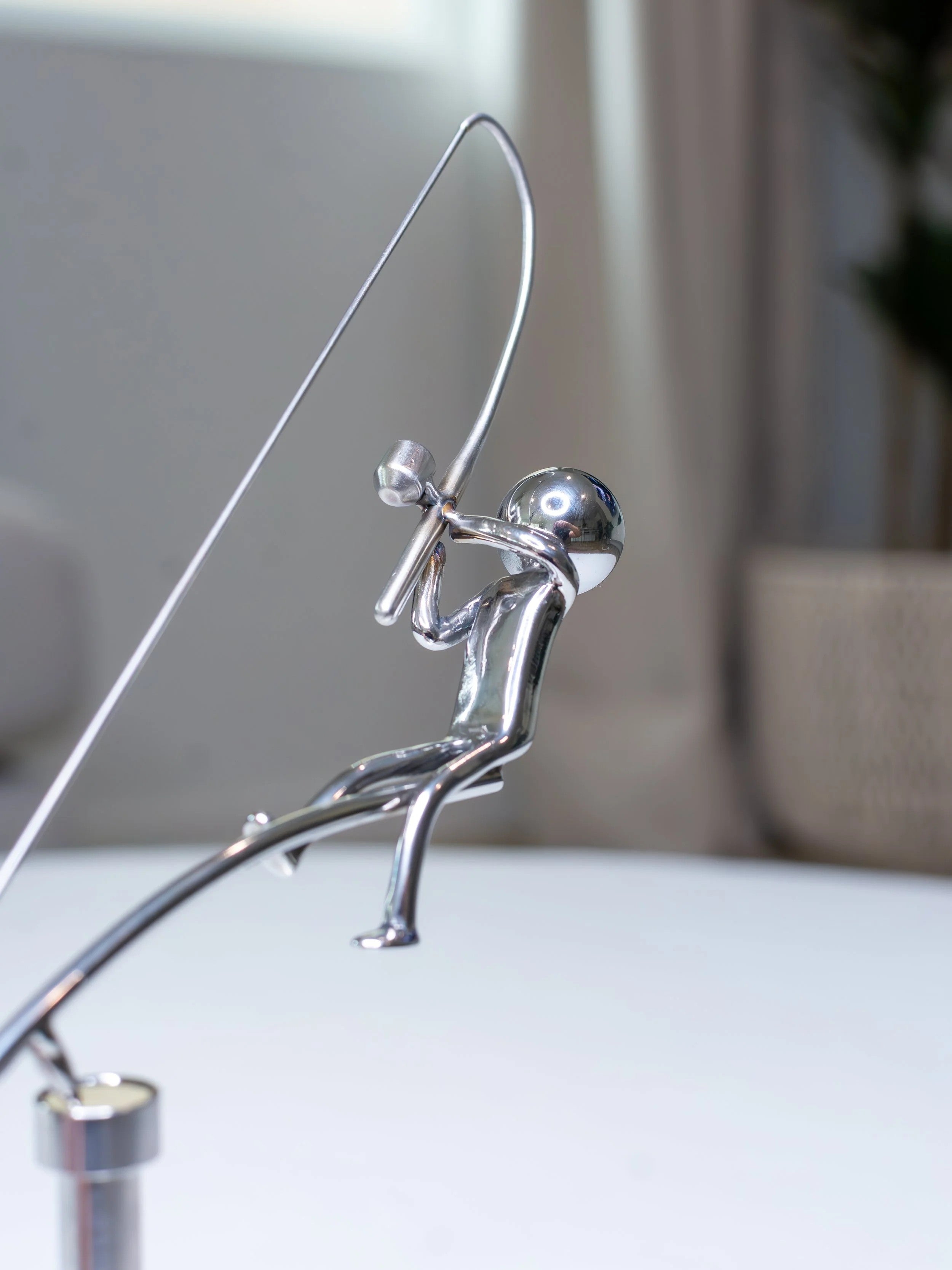 Stainless steel fishing rod and perch balance sculpture
